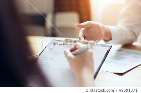 woman submit resume employer to review job. 45001371