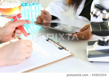 A male chemist holds test tube of glass A male chemist holds test tube of glass 45001834