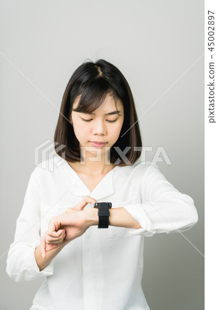 Woman touch screen digital clock in the display. Woman touch screen digital clock in the display. 45002897