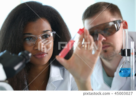 A male chemist holds test tube of glass A male chemist holds test tube of glass 45003027