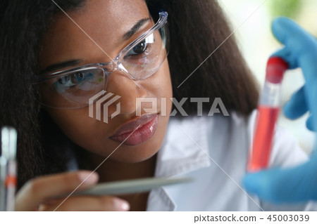 A male chemist holds test tube of glass 45003039