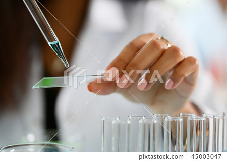 A male chemist holds test tube of glass 45003047