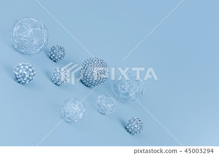 Silver shiny Christmas bauble decoration on pastel blue background. 45003294
