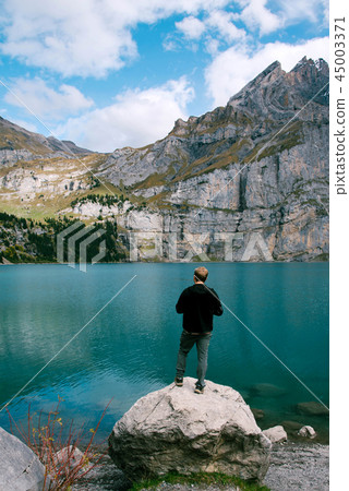 Hiker enjoing beautiful view of Lago di Braies or Pragser wildsee, Italy. Hiker enjoing beautiful view of Lago di Braies or Pragser wildsee, Italy. 45003371