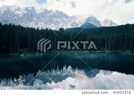 The Karersee lake with reflection of mountains in the Dolomites. The Karersee lake with reflection of mountains in the Dolomites. 45003378