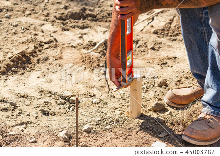 Worker Using Level At Constrcution Site Worker Using Level At Constrcution Site 45003782