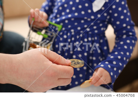 Little girl arm collecting crypto coins Little girl arm collecting crypto coins 45004708