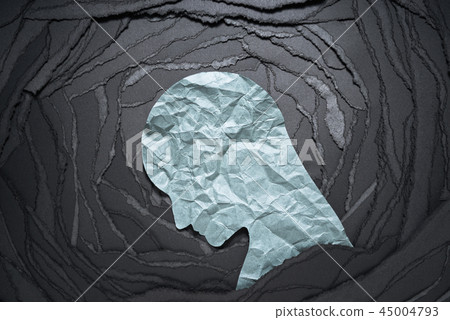 Image of negative emotions such as depression and anxiety. A torn paper background with a silhouette of a depressed man. 45004793