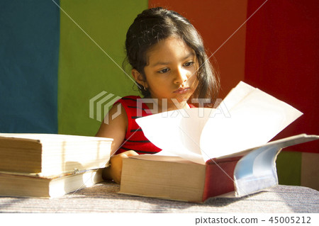 Little girl reading big books as if scholar, Pune 45005212