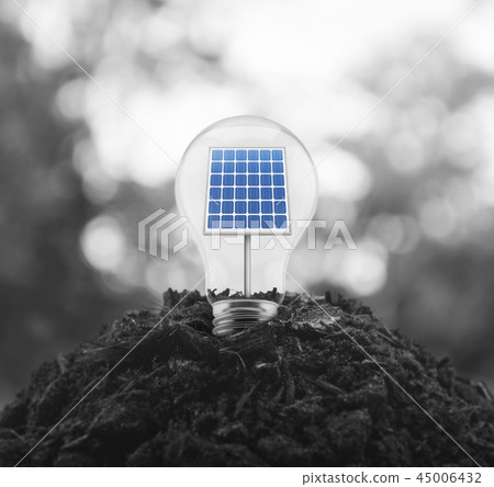 Light bulb with solar cell inside on pile of soil 45006432