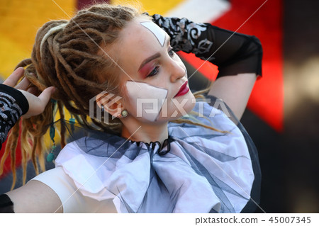 Young woman clown outdoors 45007345