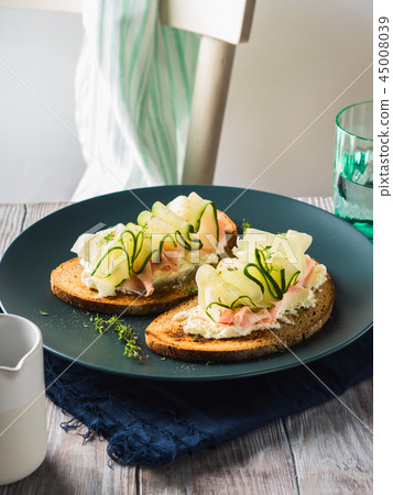 Rye bread toasts with cheese, ham, cucumber 45008039