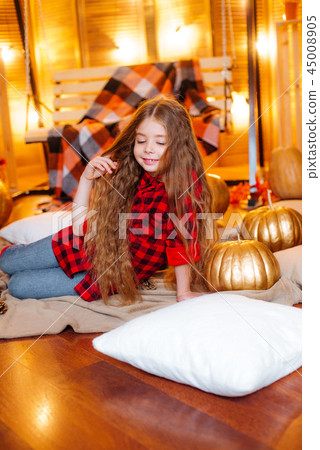 Little cute girl near the swing and pumpkins Little cute girl near the swing and pumpkins 45008905