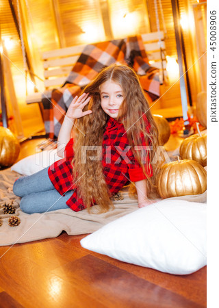 Little cute girl near the swing and pumpkins Little cute girl near the swing and pumpkins 45008906