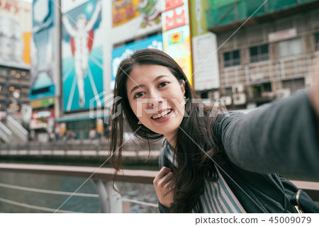 traveler taking selfie with runner sign in osaka traveler taking selfie with runner sign in osaka 45009079