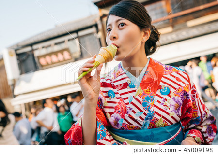 Japanese lady eating delicious matcha ice cream Japanese lady eating delicious matcha ice cream 45009198