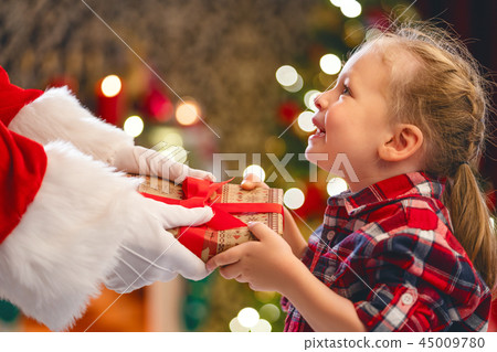 Santa Claus giving gift to child Santa Claus giving gift to child 45009780