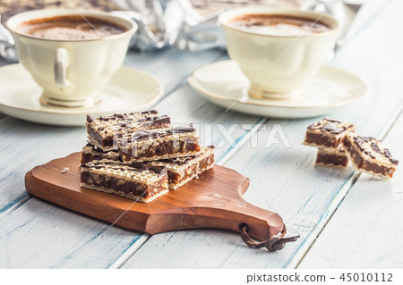 A waffle cake with caramel chocolate and walnuts. A waffle cake with caramel chocolate and walnuts. 45010112