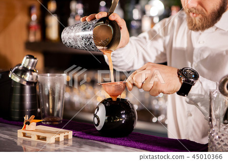 Bartender bartender is pouring a drink 45010366
