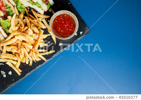 Delicious sandiwch with french fries and tasty red sos Delicious sandiwch with french fries and tasty red sos 45010377