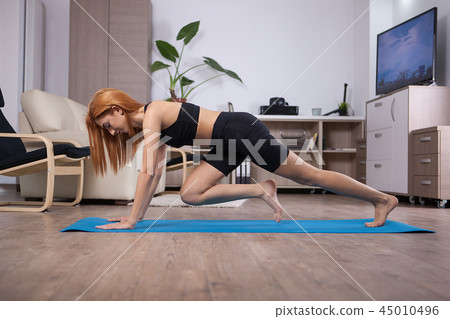 Young beautiful woman doing abs during her abs program Young beautiful woman doing abs during her abs program 45010496