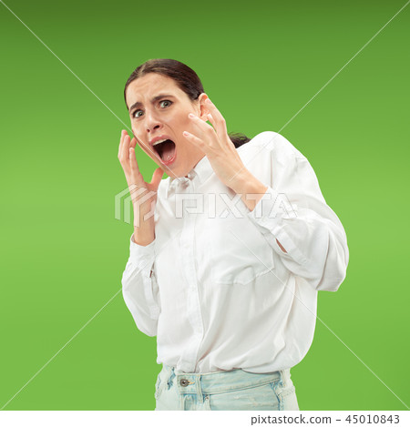 Portrait of the scared woman on green Portrait of the scared woman on green 45010843
