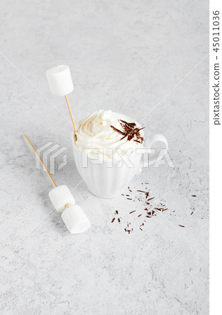 Cup of hot drink with whipped cream 45011036