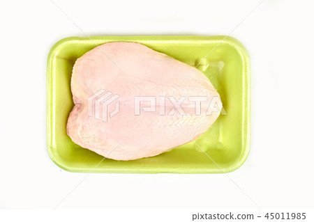 Raw chicken breast in a tray on a white background. 45011985