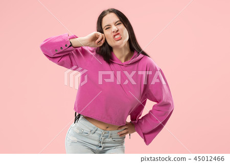 Beautiful female half-length portrait isolated on pink studio backgroud. The young emotional 45012466
