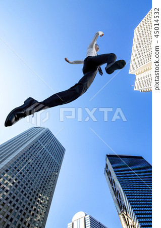 One business man in a Y-shirt wearing a blue sky and jumping on a building street. Challenge, Effort, Success, Cheerful Image 45014532