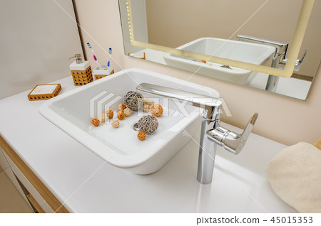 Bathroom interior detail with sink and faucet 45015353