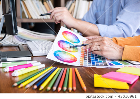 Two colleagues creative graphic designer working on color select Two colleagues creative graphic designer working on color select 45016961