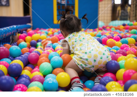 little girl having fun in ball pool little girl having fun in ball pool 45018166