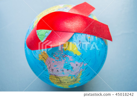 World AIDS day 1 December, close-up of world globe with red ribbon World AIDS day 1 December, close-up of world globe with red ribbon 45018242