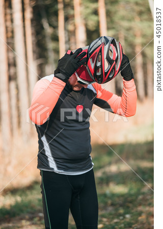 Training an athlete on the roller skaters. Biathlon ride on the roller skis with ski poles, in the Training an athlete on the roller skaters. Biathlon ride on the roller skis with ski poles, in the 45018537