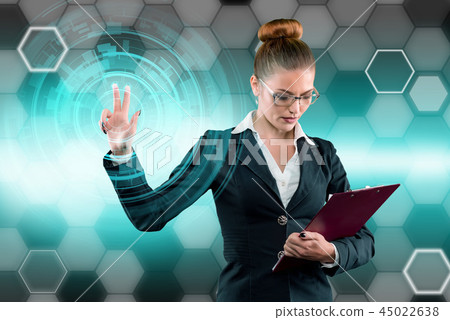 Young business lady works with virtual graphic interface in futuristic office 45022638