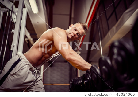 Strong Bodybuilder Doing Heavy Weight Exercise For Back 45024009