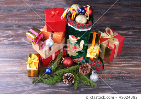 Christmas background. Advent calendar and Santa's shoe with gifts on rustic wooden table. 45024382