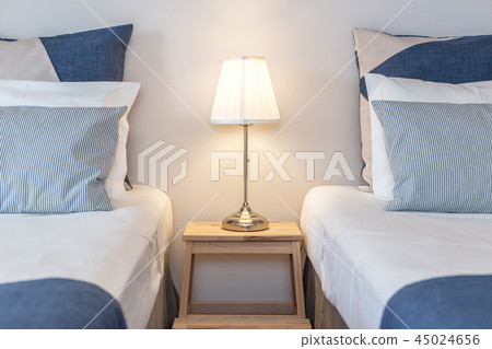 Modern bedroom with pillows and a bed for tourists. Frontally. Modern bedroom with pillows and a bed for tourists. Frontally. 45024656