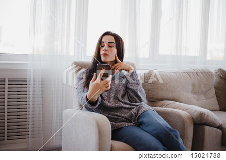 woman making selfie on mobile phone at home 45024788