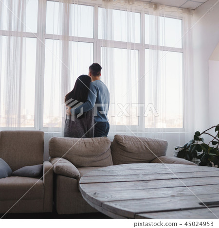 Happy new flat owners near the window 45024953