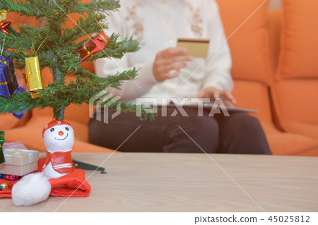 woman hold credit card & tablet for online shopping. female buyer buying christmas gift on internet. new year holiday merry xmas celebration 45025812