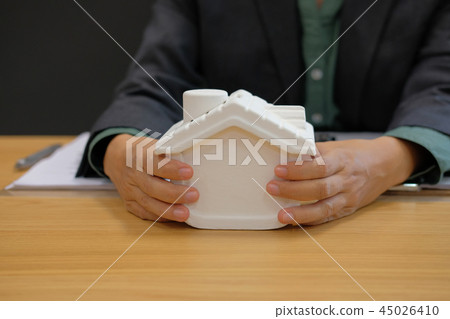 realtor agent presenting house model. buying selling renting real estate property 45026410