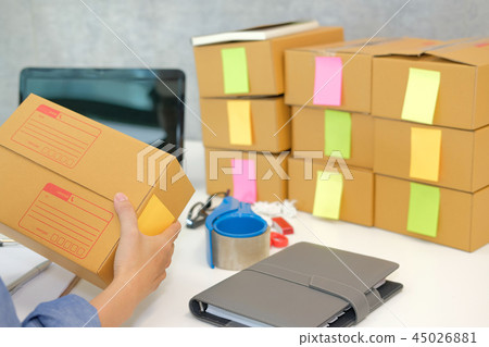 startup business owner hold cardboard box. woman seller prepare parcel box for delivery. Online selling, e-commerce concept startup business owner hold cardboard box. woman seller prepare parcel box for delivery. Online selling, e-commerce concept 45026881
