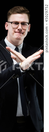 Portrait of confident handsome ambitious elegant responsible businessman showing stop gesture on Portrait of confident handsome ambitious elegant responsible businessman showing stop gesture on 45029752