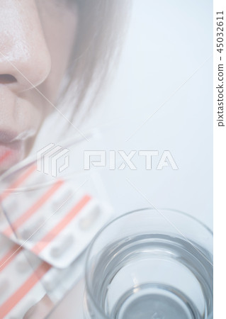 Woman taking medicine Woman taking medicine 45032611