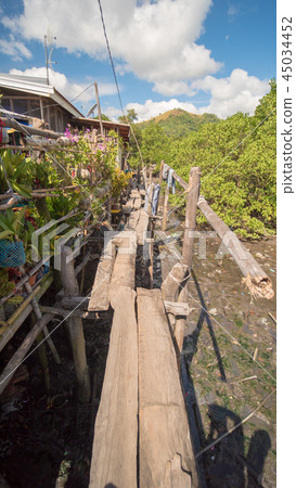 The bridge of the plaques in the poor district of Coron town. Busuanga. Views of the city's Slums The bridge of the plaques in the poor district of Coron town. Busuanga. Views of the city's Slums 45034452
