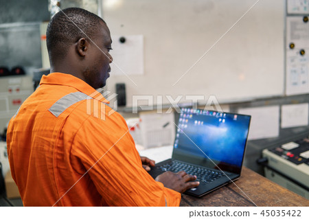 Marine engineer officer working in engine room Marine engineer officer working in engine room 45035422