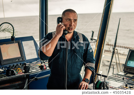 Marine navigational officer is reporting by VHF radio 45035428