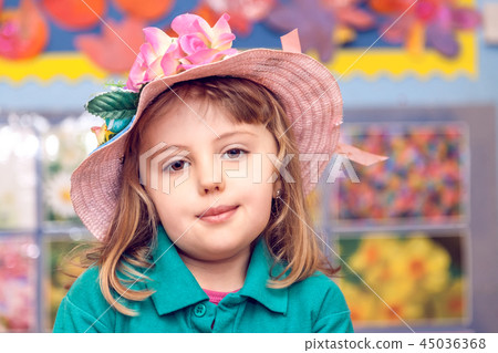 Cute little girl wearing pink wicker hat 45036368